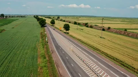 Altitude view of the highway among the fields Stock Footage 197386658