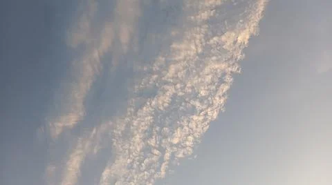 Altocumulus cloud formations in blue sky with sunlight texture Stock Photos