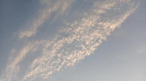 Altocumulus cloud formations in blue sky with sunlight texture Stock Photos