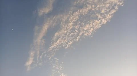 Altocumulus cloud formations in blue sky with sunlight texture Stock Photos
