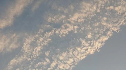 Altocumulus cloud formations in blue sky with sunlight texture Stock Photos