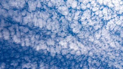 Altocumulus cloud layer covering blue sky in uniform pattern for meteorological Stock Photos