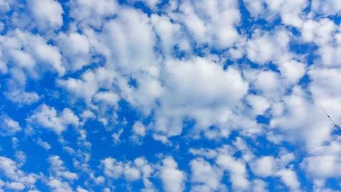 Altocumulus cloud patterns in the clear blue morning sky. Stock Photos