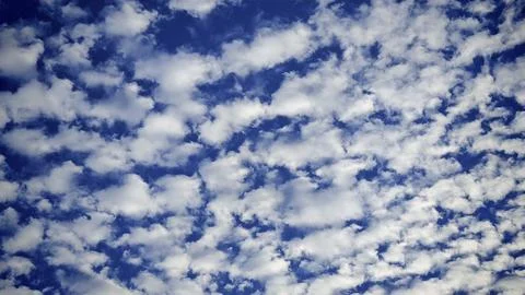 Altocumulus clouds against a blue summer sky with a white cloud cover, Stock Photos