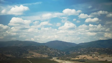 Altocumulus clouds crossing the sky above a mountain Stock Footage 116663046