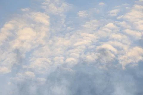 Altocumulus patterned clouds spreading over blue sky in daytime background Stock Photos