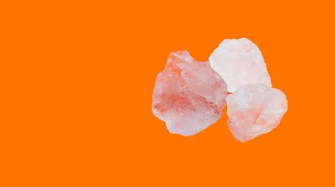 Alum cubes on orange background Stock Photos