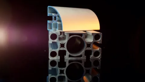 Aluminium profile with a rounded cover on a dark reflective table, Close Up Stock Footage 342289799