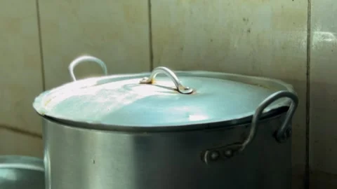Aluminum Cooking Pot With Lid in Rustic Kitchen Interior Stock Footage 332545669