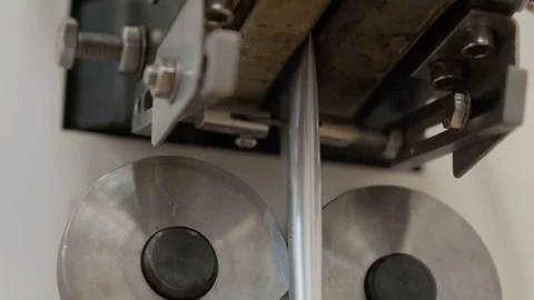 Aluminum foil is passed through press,compressed and divided into oblong packets Stock Footage 127777671