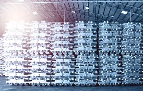 Aluminum ingot bar stack in warehouse for supplying to factory. Stock Photos
