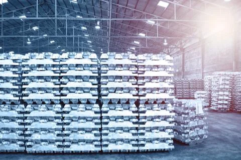 Aluminum ingot bar stack in warehouse for supplying to factory. Stock Photos