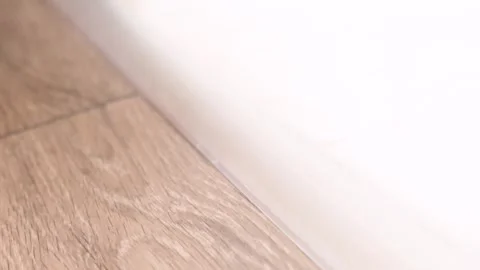 Aluminum threshold between ceramic tiles and parquet. Aluminum plat band, f.. Vídeos de archivo 247958555