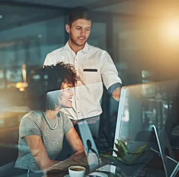 Always making the right decision. young employees working late into the evening. Stock Photos