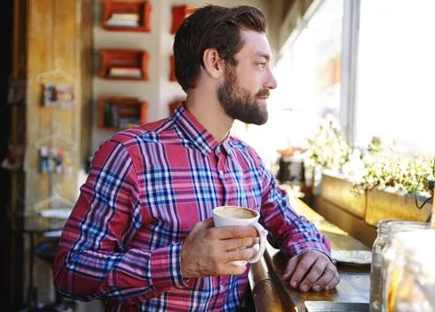 Always start the day with a refreshing cup of coffee. a young man drinking Stock Photos