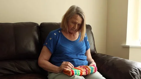 Alzheimer patient using a Twiddle Muff Stock Footage 247136651