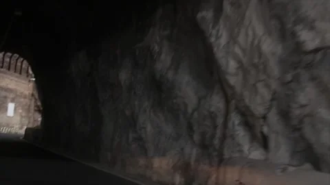 Amalfi coast driving toward and through mountain tunnel shot from moving vehicle Stock Footage 252149285
