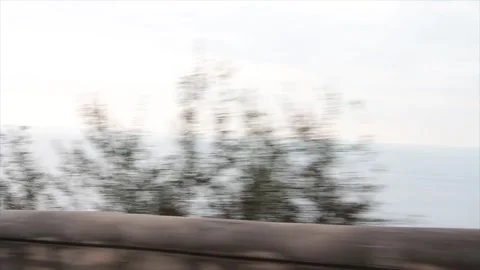 Amalfi coast mountain driving around bend with trees and view of water ocean Stock Footage 252149198