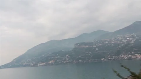 Amalfi coast mountain tip in water wide shot from moving driving vehicle Stock-Footage 252150086