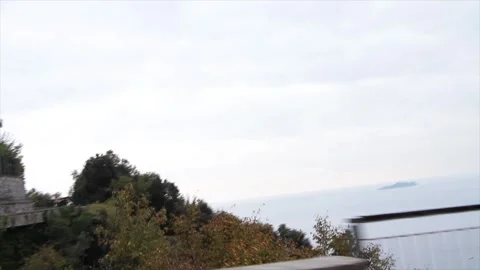 Amalfi coast mountain tips in water shot from moving vehicle turning to reveal Video stock 252149171