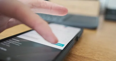 AMan's finger presses checkout button on smartphone screen. Side view, close-up Stock Footage 255767002