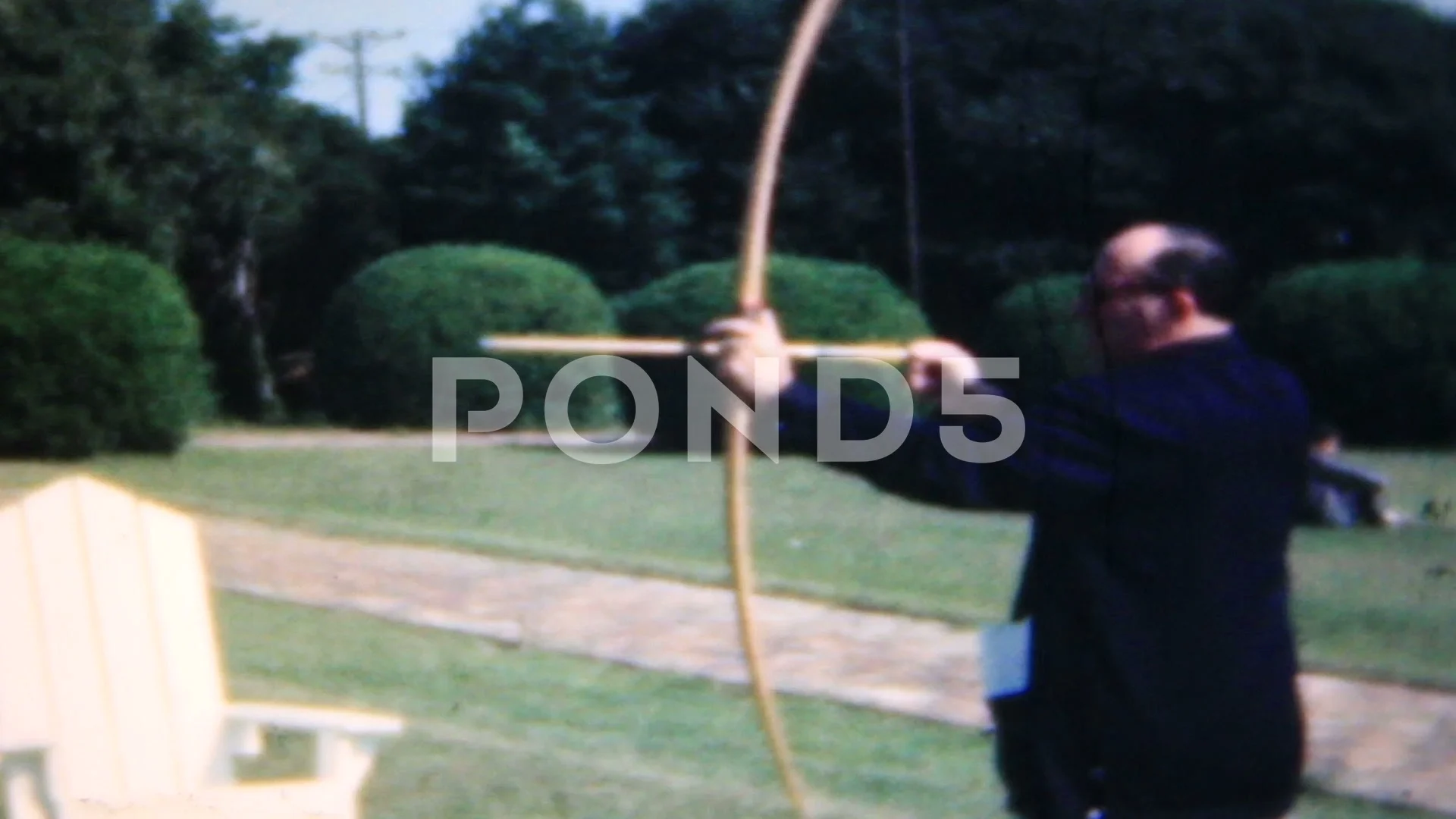 amateur archers without lessons try to hit a target 1950s family home movie 6456 photo