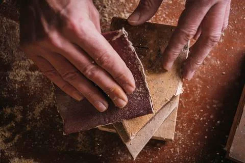 Amateur carpenter uses sandpaper on wood Stock Photos
