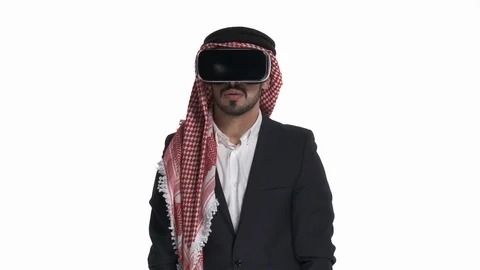 Amazed Arab bearded man using VR headset to play games, isolated on white. 3D Stock Footage 125830687