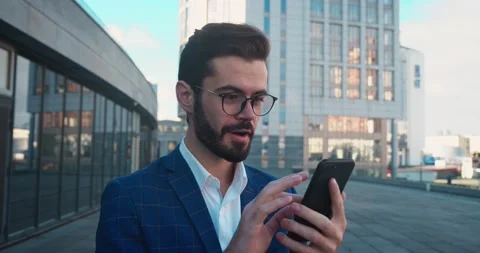 Amazed bearded man looking at smartphone and saying WOW. Pleasantly surprised Stock Footage 165001817