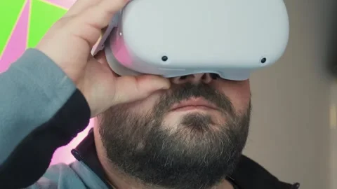 Amazed bearded man wearing virtual reality glasses. Male in VR headset. Modern Stock Footage 270595155