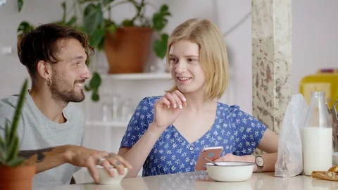 Amazed blonde female pulls hand to tasty fruits plate while male quickly taking Stock Footage 108796537