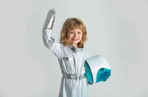 Amazed boy playing to be an astronaut with space helmet and metal suit. Stock Photos