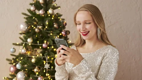 Amazed christmas woman using mobile phone, sees message and says wow Stock Footage 166323160