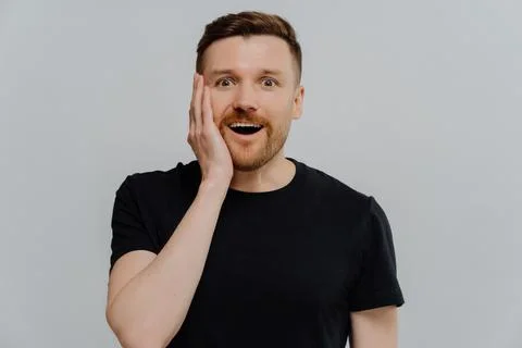 Amazed ginger man staring at camera with shocked happy expression Stock Photos