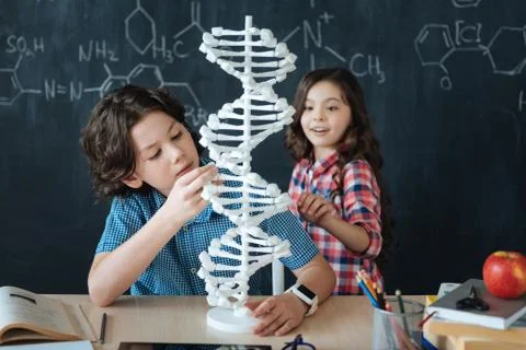 Amazed kids studying genetic code at school Foto stock