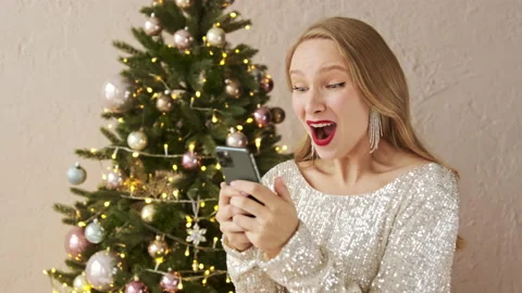 Amazed lucky christmas woman using phone and scream wow, winner Stock Footage 166323288