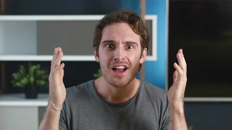 Amazed man looking at camera and saying WOW. Pleasantly surprised young male on Stock-Footage 142542802