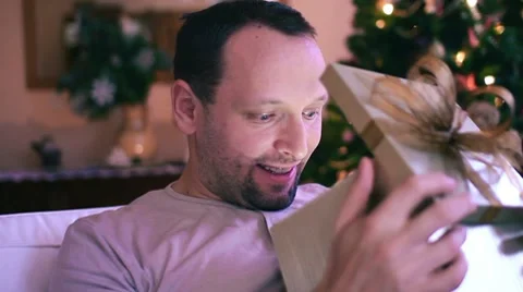 Amazed man looking at something magical in gift box HD Stock Footage 10608237