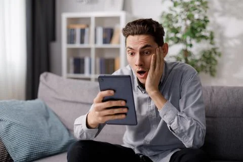 Amazed man looking on tablet Stock Photos