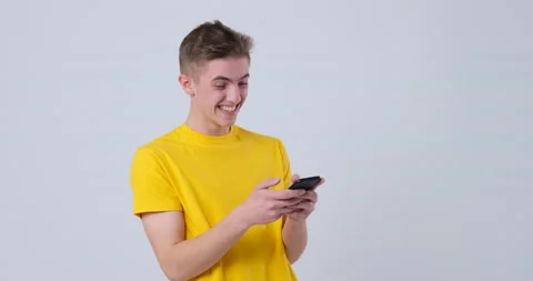 Amazed Man typing messege with mobile phone Stock Footage 144958829