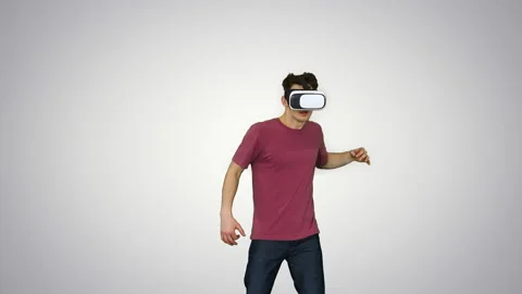 Amazed man using VR headset glasses touching and interacting with virtual Stock Footage 130698134