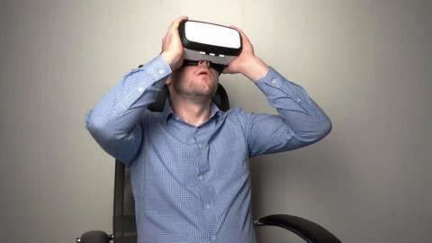 Amazed man wearing VR headset Stock Footage 104055906
