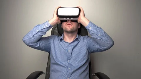 Amazed man wearing VR headset Stock Footage 104056013