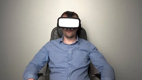 Amazed man wearing VR headset Stock Footage 104056410