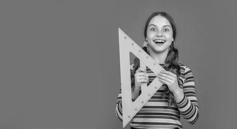 Amazed school child hold math tool of triangle Stock Photos