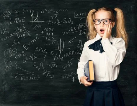 Amazed School Child Learning Math, Chalk Mathematics Formulas on Blackboard Stock Photos