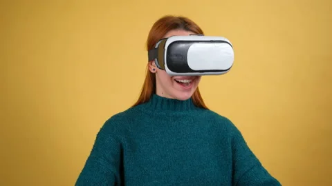 Amazed woman using VR app headset helmet to play simulation game, drawing Video stock 150112626