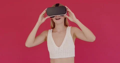 Amazed woman using VR app headset helmet to play simulation game Stock Footage 204940771