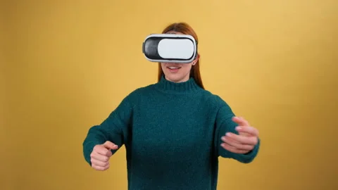 Amazed woman using VR headset glasses touching and interacting with virtual Stock Footage 148677590