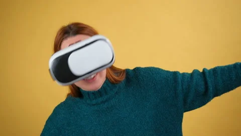 Amazed young woman using VR app headset helmet to play simulation game, drawing Stock Footage 150054849